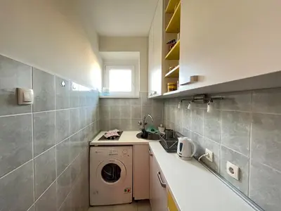 a kitchen with a washing machine and a sink at Bright modern downtown studio in Belgrade