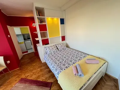 a small bedroom with a bed with towels on it at Bright modern downtown studio in Belgrade