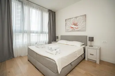 a bedroom with a bed with towels on it at Velora BW Metropolitan in Belgrade