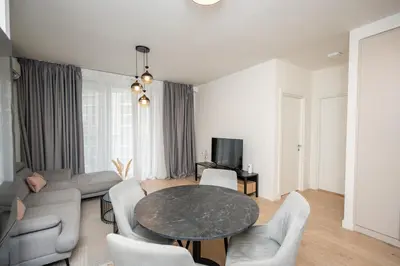 a living room with a table and chairs at Velora BW Metropolitan in Belgrade