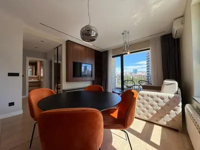 a living room with a table and chairs and a couch at BW Home in Belgrade