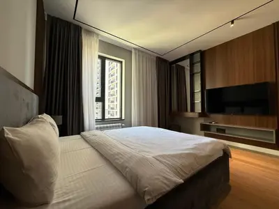 a bedroom with a bed and a television in it at BW Home in Belgrade