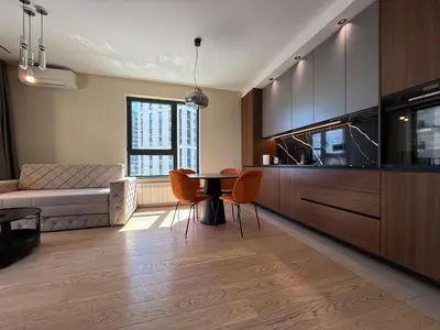 a kitchen and living room with a table and a couch at BW Home in Belgrade