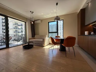 a kitchen and living room with a table and chairs at BW Home in Belgrade