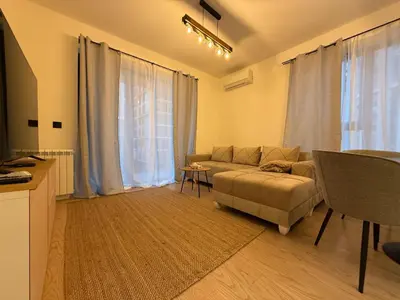 a living room with a couch and a table at BW Home in Belgrade