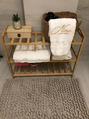 a towel rack with towels and a pile of towels at Apartman Nina Banovci in Novi Banovci