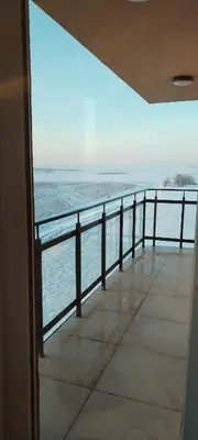 a view of the ocean from a balcony at Apartman Nina Banovci in Novi Banovci