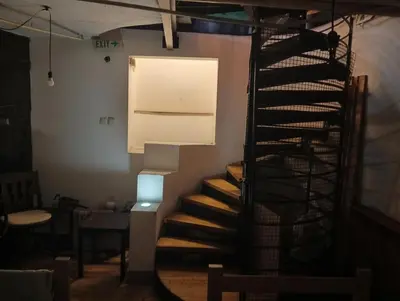 a spiral staircase in a room with a light at Bar apartment in Belgrade