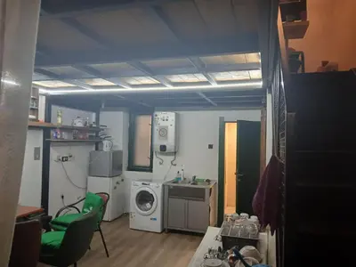 a small kitchen with a washing machine and a washer at Bar apartment in Belgrade