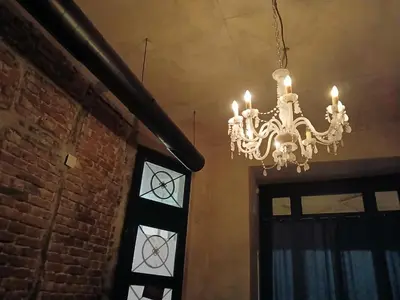a chandelier hanging from a ceiling next to a door at Bar apartment in Belgrade