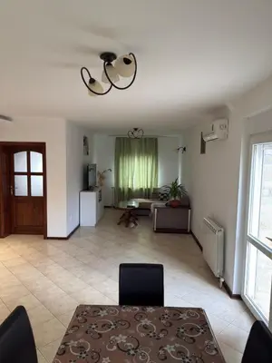 a living room with a table and a couch at Elegance Apartman in Belgrade