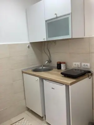 a small kitchen with a sink and a counter at Apartman General in Belgrade
