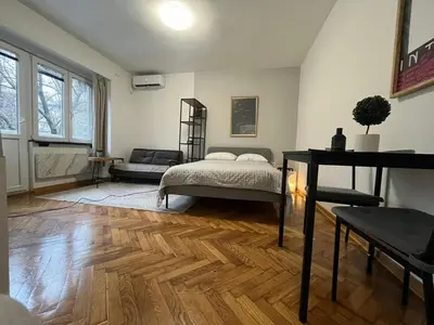 a bedroom with a bed and a couch in it at Apartman General in Belgrade