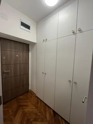 a room with white cabinets and a closet at Apartman General in Belgrade