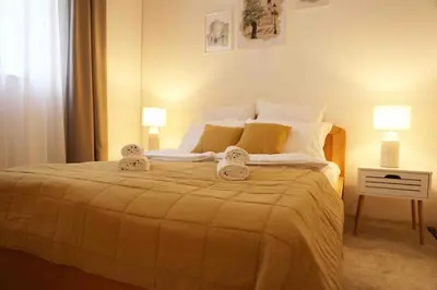 a bedroom with a bed with two towels on it at VD City Centre Apartment Belgrade in Belgrade