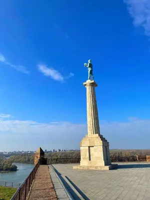 a statue of a man on a pole on a bridge at VD City Centre Apartment Belgrade in Belgrade