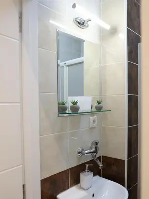 a bathroom with a sink and a mirror at VD City Centre Apartment Belgrade in Belgrade