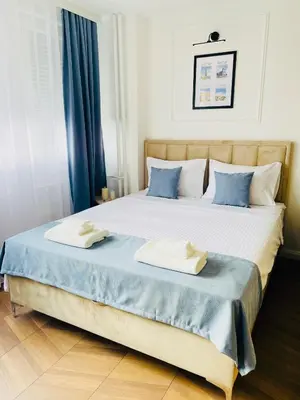 a bedroom with a large bed with two towels on it at Fontana Lux Apartment in Belgrade