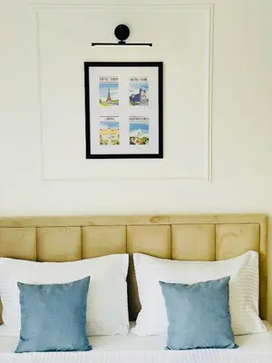 a bed with white pillows and a picture above it at Fontana Lux Apartment in Belgrade