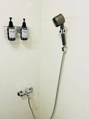 a shower with a blow dryer in a bathroom at Fontana Lux Apartment in Belgrade