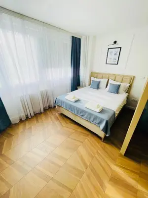 a bedroom with a bed and a wooden floor at Fontana Lux Apartment in Belgrade