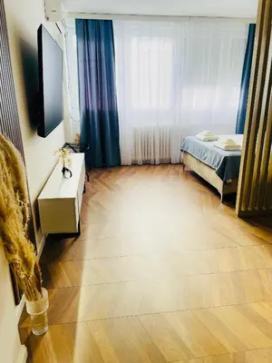a room with a bedroom with a bed and a television at Fontana Lux Apartment in Belgrade