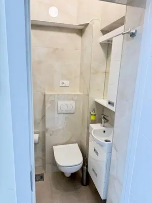 a small bathroom with a toilet and a sink at Natalie's Prestige in Belgrade