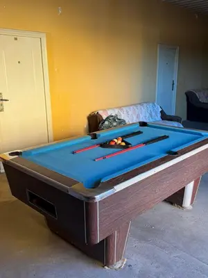 a pool table sitting in a living room with at Pecinci Hostel in Pećinci