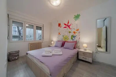 a bedroom with a large bed with two towels on it at COZY Urban Heaven in Belgrade