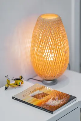 a book on a table next to a lamp and a magazine at COZY Urban Heaven in Belgrade