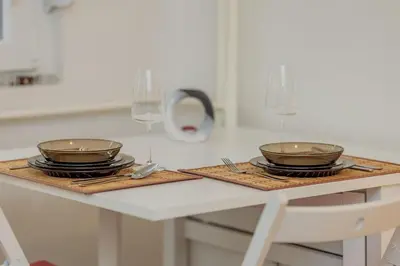 a table with two bowls and plates on it at COZY Urban Heaven in Belgrade