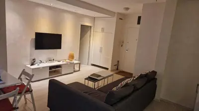 a living room with a couch and a tv at COZY Urban Heaven in Belgrade