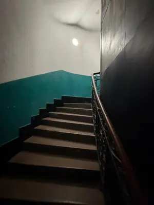 a staircase in a building with a green wall at Knez Mihailova street in Belgrade in Belgrade