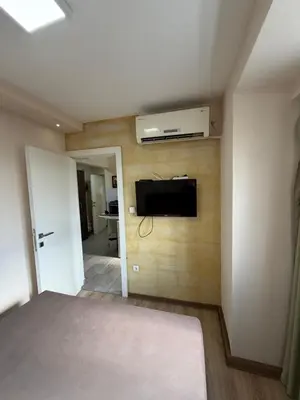 a bedroom with a bed and a tv on a wall at Knez Mihailova street in Belgrade in Belgrade