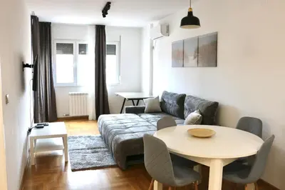 a living room with a couch and a table at Dok city apartman in Belgrade
