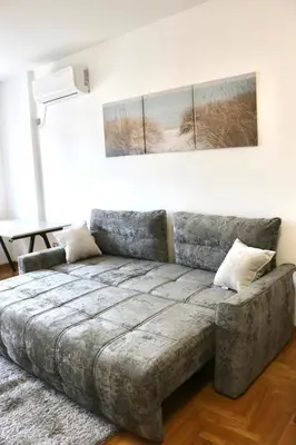 a living room with a couch in a room at Dok city apartman in Belgrade