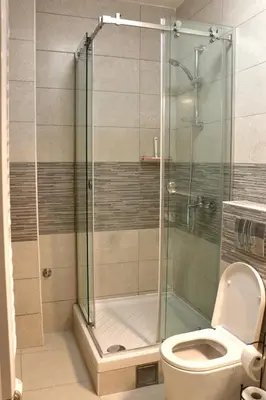 a bathroom with a shower and a toilet at Dok city apartman in Belgrade