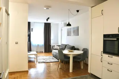 a living room with a couch and a table at Dok city apartman in Belgrade
