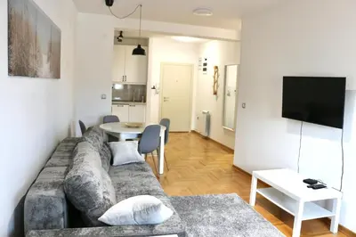 a living room with a couch and a table at Dok city apartman in Belgrade