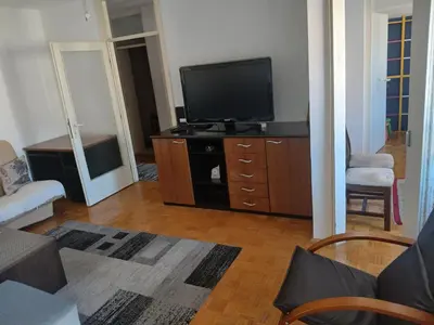 a living room with a flat screen tv on a dresser at Bezanija86 in Belgrade