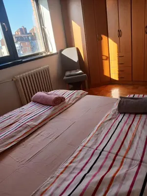 a large bed in a room with a large window at Bezanija86 in Belgrade