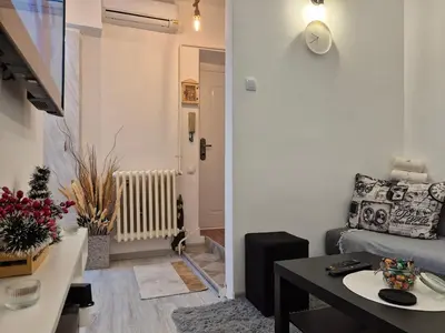 a living room with a couch and a table at Vracar Cozy Nook in Belgrade