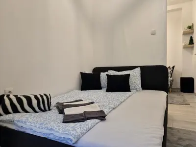 a bed with two towels on it in a bedroom at Vracar Cozy Nook in Belgrade