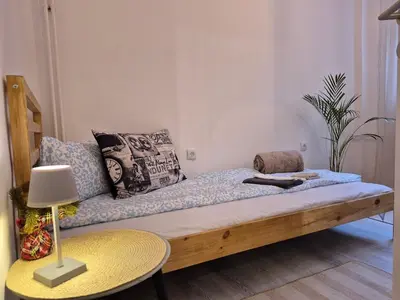 a couch in a living room with a table at Vracar Cozy Nook in Belgrade