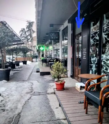 an empty street with benches and tables in a store at Vracar Cozy Nook in Belgrade