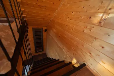 an attic room with a staircase in a wooden wall at Danube Retreat in Belgrade