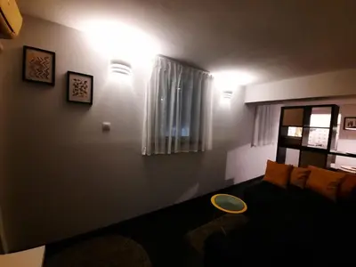 a living room with a couch and a window at Comfort Studio in Belgrade