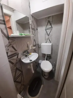 a small bathroom with a toilet and a sink at Comfort Studio in Belgrade