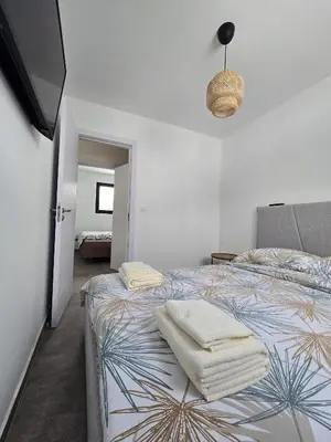a bedroom with a bed with towels on it at Lake & Pool Paradise in Karaula