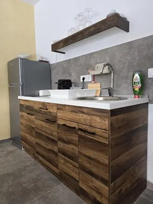 a kitchen with a sink and a refrigerator at Lake & Pool Paradise in Karaula